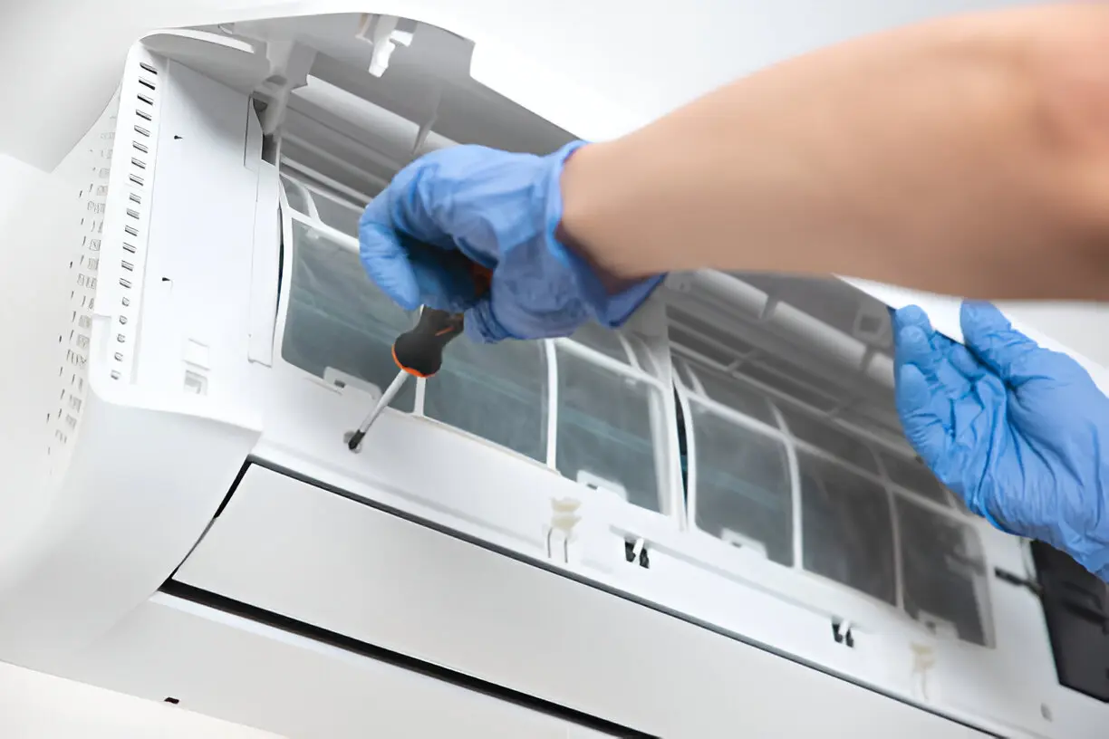 Home 10 HVAC technician performing late-night emergency AC repair in an Orlando home